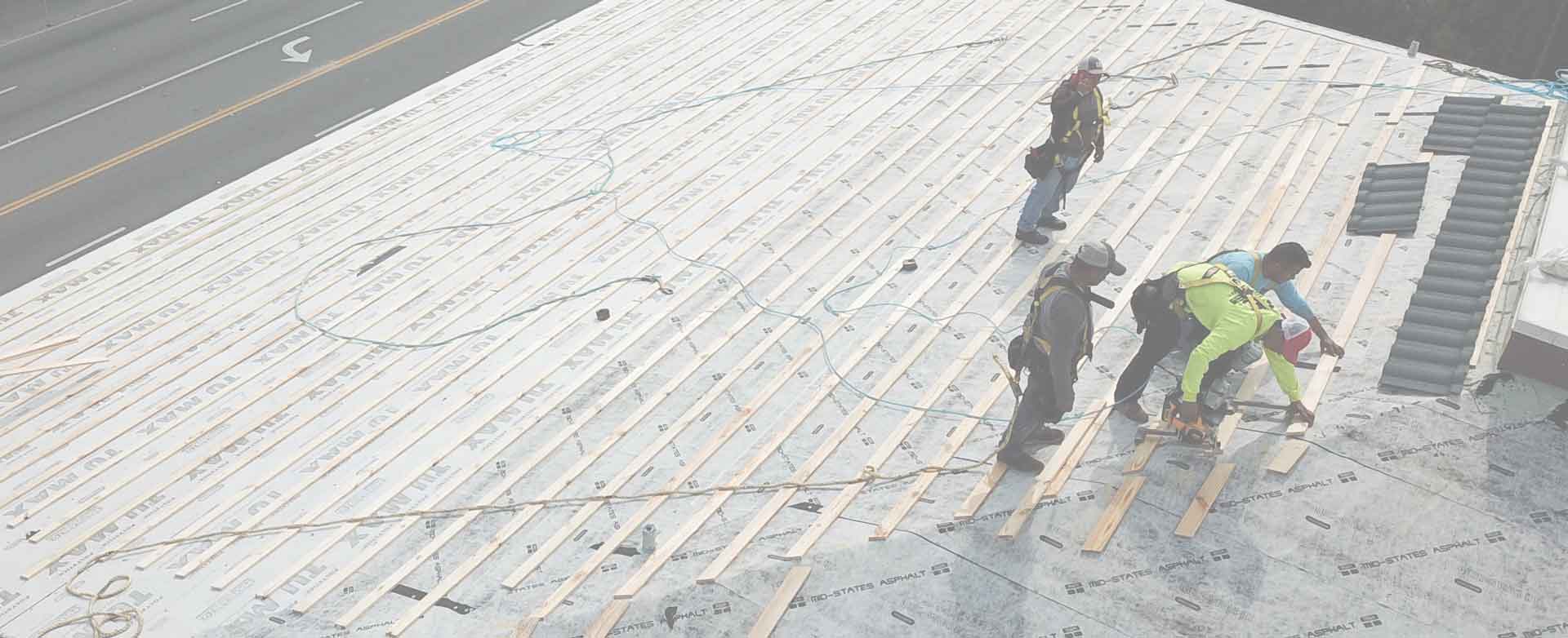 Roofing crew installing a new roof deck
