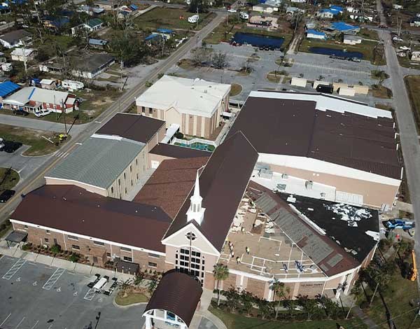 Aerial view of a church campus during storm roof restoration