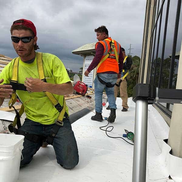 Roofing crew working on a commercial roof