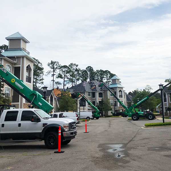 Multiple lifts staged at an apartment complex